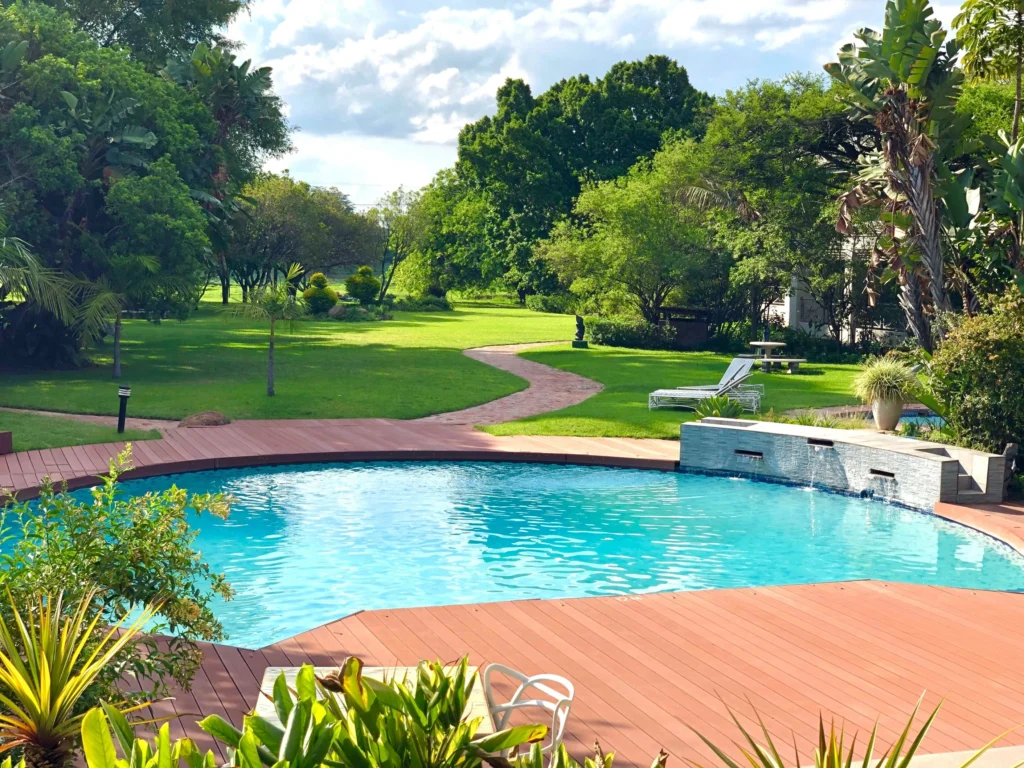 Backyard pool with a clean surface and pool house