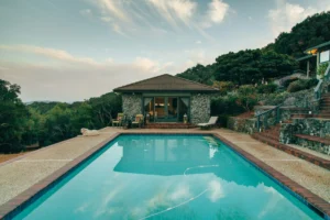 Landscaped backyard pool with a wood deck and clear water